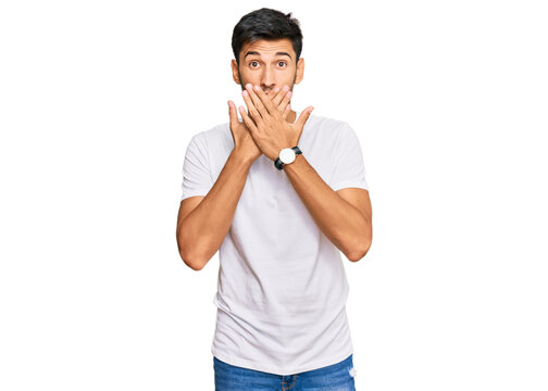 Young handsome man wearing casual white tshirt shocked covering mouth with hands for mistake. secret concept.