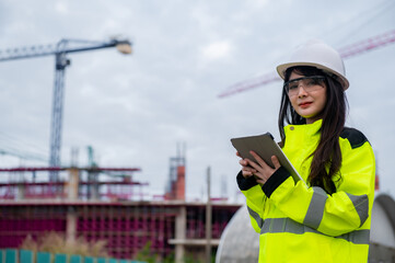 Asian engineer working at site of a large building project,Thailand people,Work overtime at construction site