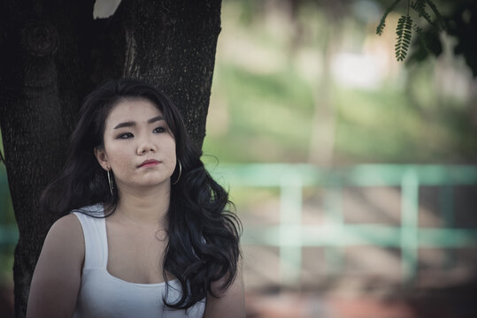 Beautiful thai woman very sad from unrequited love,She rethink and think over about love,vintage style,dark tone,broken heart,asian girl think a lot because she fat