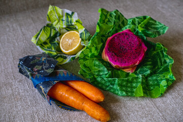 Wrapped fruits and vegetables in environmentally safe beeswax wrap. Reusable eco-friendly kitchen products. Zero waste sustainable plastic free lifestyle