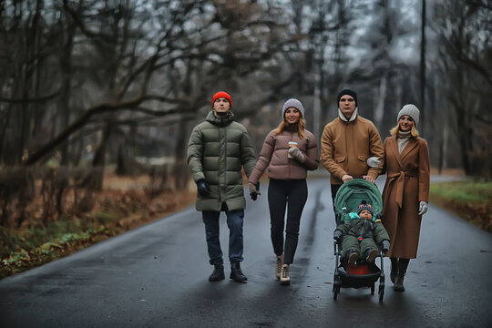 group friends adults park gloomy autumn, young parents walk landscape november in the city