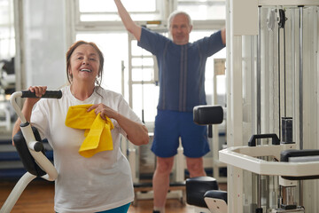 Fototapeta na wymiar Happy senior woman after hard training at gym. Elderly woman at fitness center. Sport and seniors.
