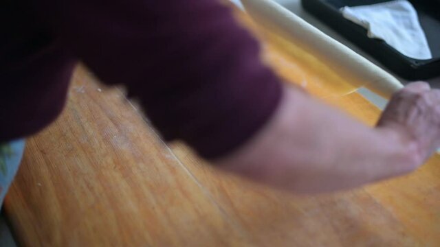 hands making dough on kitchen table