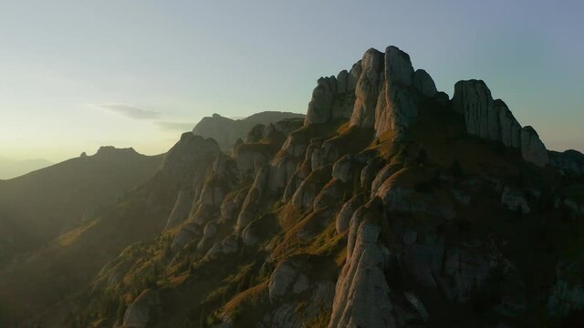Camera dolly out across mountain peaks over Ciucas Peak, Romania
