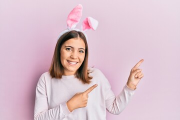 Young caucasian woman wearing cute easter bunny ears touching mouth with hand with painful expression because of toothache or dental illness on teeth. dentist
