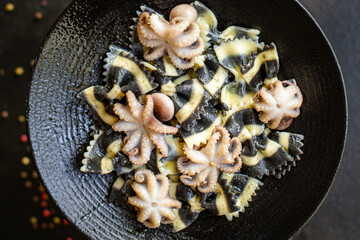 pasta ink cuttlefish seafood farfalle with baby octopus small octopuses second course snack ready to eat on the table healthy meal snack ingredient top view copy space for text food background rustic