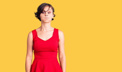 Obraz premium Beautiful young woman with short hair wearing casual style with sleeveless shirt puffing cheeks with funny face. mouth inflated with air, crazy expression.