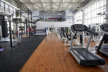 Gym interior with equipment. Treadmills for fitness cardio training. Sport club for fitness workout.