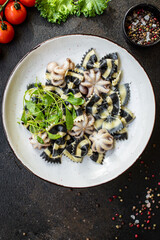 pasta ink cuttlefish seafood farfalle with baby octopus small octopuses second course snack ready to eat on the table healthy meal snack ingredient top view copy space for text food background rustic