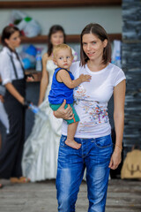 Beautiful young mother with her little son in her arms