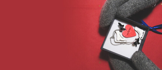 The girl in winter gloves opened the gift. Category: New Year, Valentine's Day, March 8th, Birthday.           
