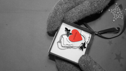 The girl in winter gloves opened the gift. Category: New Year, Valentine's Day, March 8th, Birthday.           