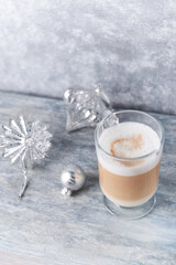 Coffee with milk and Christmas ornaments on rustic wooden background.	