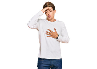 Fototapeta premium Handsome caucasian man wearing casual white sweater touching forehead for illness and fever, flu and cold, virus sick