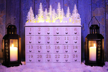 Christmas boxed advent calendar with candle lit lanterns.