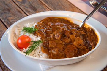 Traditional Serbian rustic dish - venison gulash with mushroom sauce and boiled rice