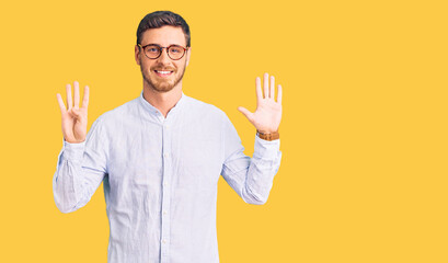 Handsome young man with bear wearing elegant business shirt and glasses showing and pointing up with fingers number nine while smiling confident and happy.