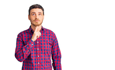 Handsome young man with bear wearing casual shirt thinking concentrated about doubt with finger on...