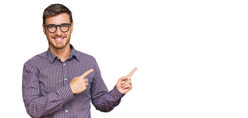 Handsome caucasian man wearing casual clothes and glasses smiling and looking at the camera...