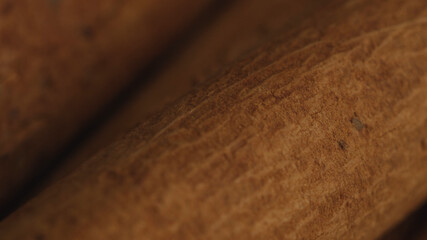 Cinnamon sticks on a dark background.  Spicy cinnamon seasoning for baked goods, fruit desserts,...