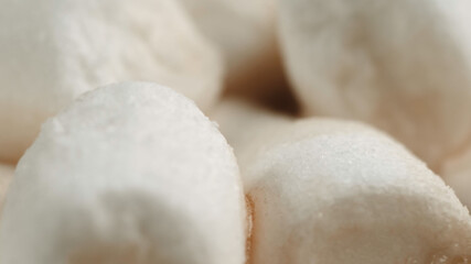 Fototapeta na wymiar Many delicious sweet white marshmallows close-up. Swim on cocoa. Macro shooting. A cup of hot cocoa chocolate sprinkled. Soft focus, depth of field