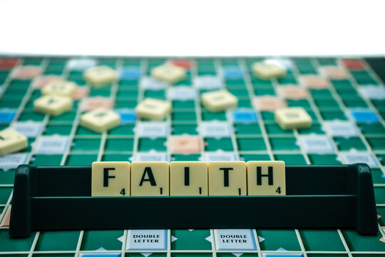 08/08/2020 Portsmouth, Hampshire, UK The Word faith spelled with scrabble tiles on a scrabble board