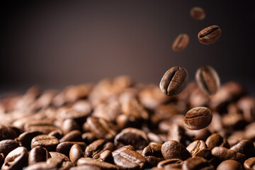 Coffee beans at the fabrique. Coffee beans fall on the table. Background made of falling down fresh...