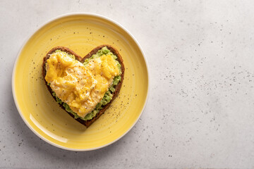 heart shaped healthy avocado toast with scrambled egg