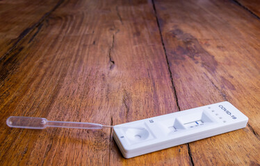 Thame,UK 30 Oct 2020: Closeup on Coronavirus antibody test kit on rustic wooden table, tests provided randomly by NHS in UK to see how many people were infected with virus