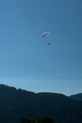 paragliding in the blue sky,flying, parachute, sport, paraglider, extreme, air, freedom, adventure, glider,sports, activity, fun,wind, mountain,