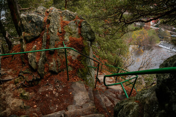 Fototapeta premium Viewpoint above Jizera valley near castle Vranov, Iron green ladder to the top of the sandstone rocks, Hiking Golden Trail of Bohemian Paradise, Mala Skala, Czech Republic