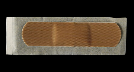 Adhesive band aid isolated on black background, top view