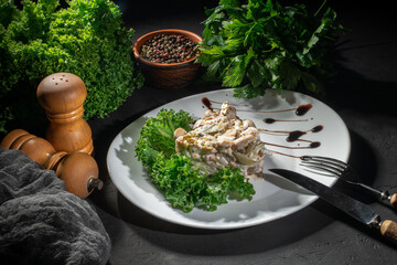 Salad with chicken and mushrooms with vegan mayo on dark background