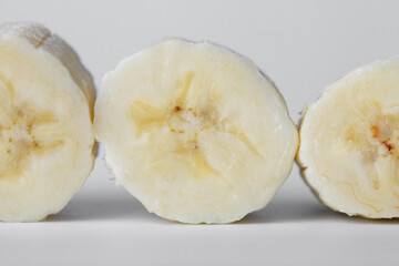 Sliced banana slices on a white background close-up