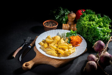 Baked potat and vegetables on dark background