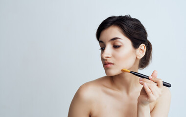 Fototapeta premium Cute brunette cosmetics facial skin care close-up