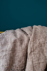 Linen fabric on dark turquoise background. natural fabric rolls. various linen colors