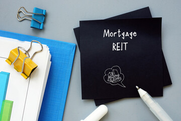 Financial concept about Mortgage REIT with sign on the piece of paper.