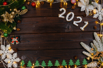 Fototapeta na wymiar Brown Christmas background decorated with festive Christmas decor and accessories, garland. Festive new year's card