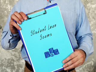 Financial concept about Student Loan Scams with phrase on the sheet.