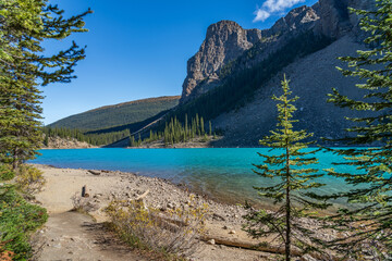 Fototapeta premium Moraine lake beautiful landscape in summer sunny day morning. Sparkle turquoise blue water, snow-covered Valley of the Ten Peaks. Banff National Park, Canadian Rockies, Alberta, Canada