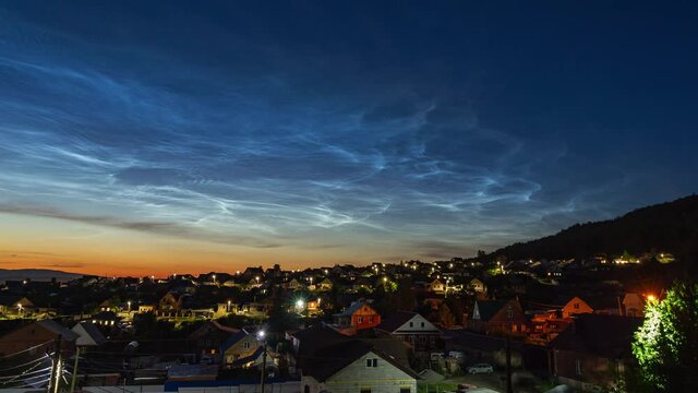 noctilucent silver clouds in the sky above the village 4k time lapse video