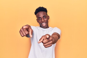 Young african american man wearing casual clothes pointing to you and the camera with fingers, smiling positive and cheerful