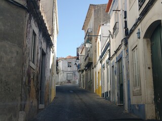 Old empty Portuguese town with narrow streets and beaten buildings