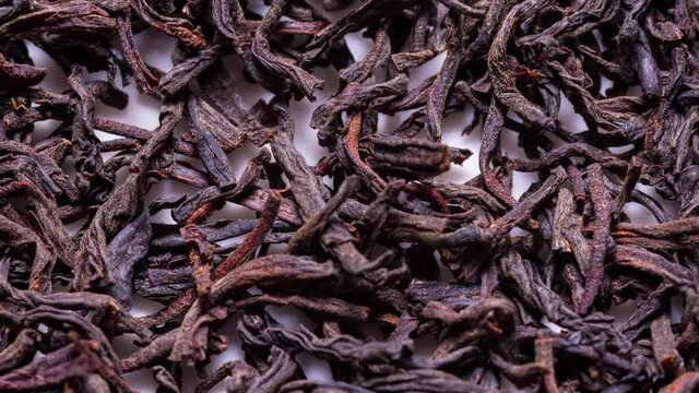 Animated stop motion texture Dried black tea leaves, textured background