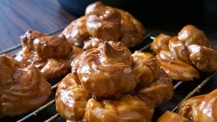 Fresh delicate pastry glazed by caramel topping ready to be assembled