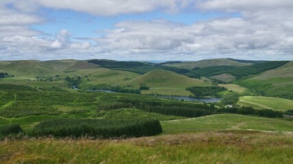 View of Glendevon, Castlehill Reservoir and green Ochil Hills from the peak of a hill above Muckhart