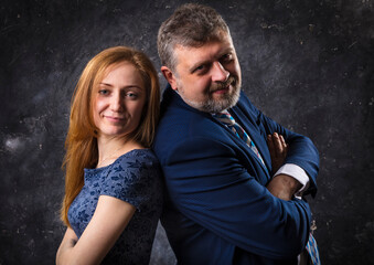 Bearded man and young woman, happy couple studio portrait