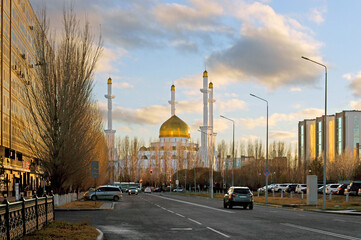 Fototapeta na wymiar Golden domes of Nur-Astana Mosque at sunset. Nur Sultan