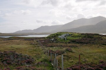 Misty view of mountains over peat land and Loch Druidibeag on South Uist, Outer Hebrides